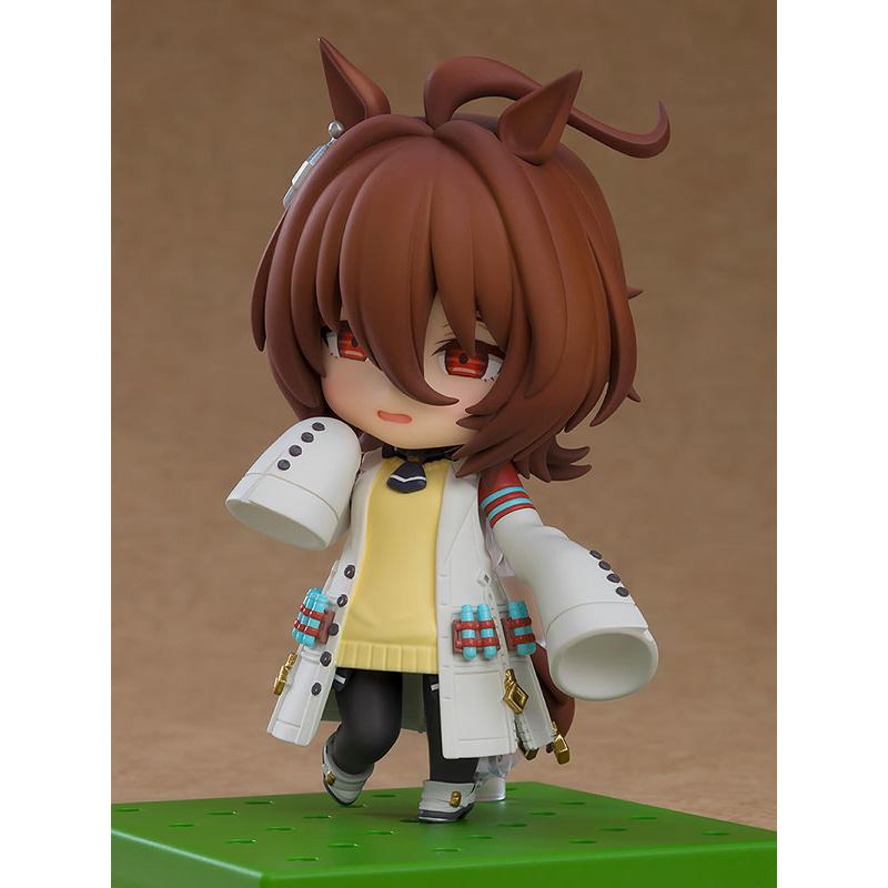 A chibi anime horse girl figure with brown hair on a green base against a plain brown background.