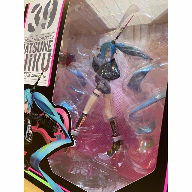 A boxed Hatsune Miku figure in a clear plastic window package with pink interior.