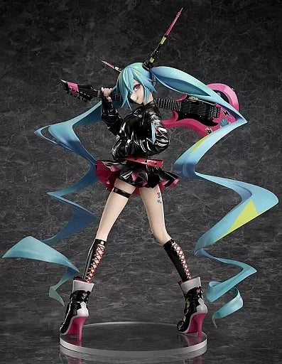 Hatsune Miku figure posed with long ribbon-like hair strands on a dark studio background.