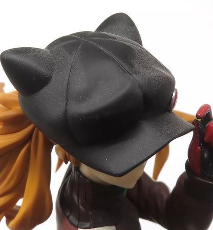 Close-up of an orange-haired anime figure wearing a black cat-eared hat.