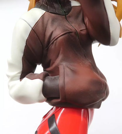 Close-up of a figure wearing a brown jacket and red pants on a white background.