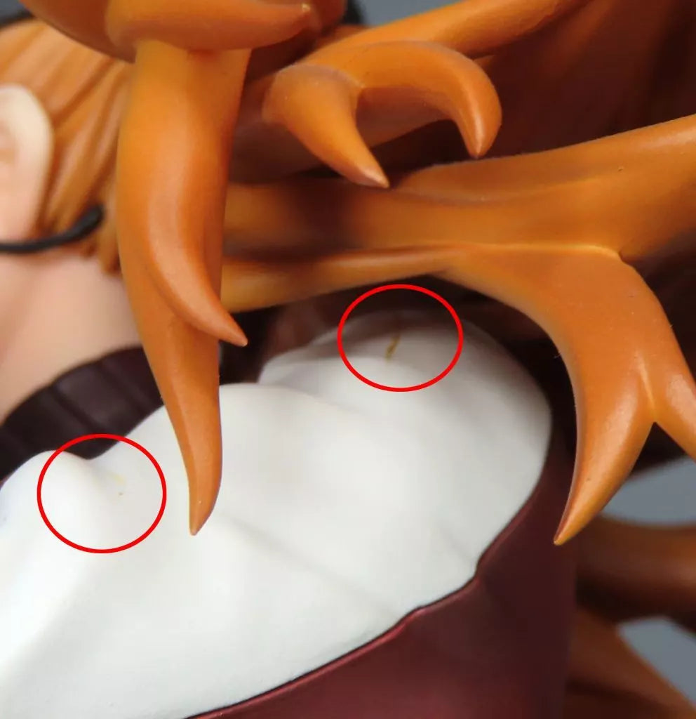 Close-up of an Asuka figure's orange hair and white outfit with two circled marks.