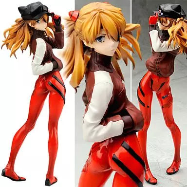 Three studio views of a blonde anime figure in a red and brown outfit and black cap.