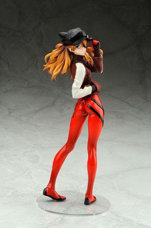 A red-haired anime figure posing on a clear round base against a light studio background.