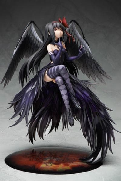A winged dark-haired anime figure posed on a round base against a light studio background.