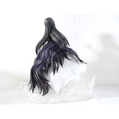 A black-haired figure with flowing purple-black hair seen from the back on a white surface.