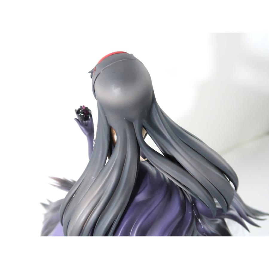 Rear view of a dark-haired anime figure against a plain white background.