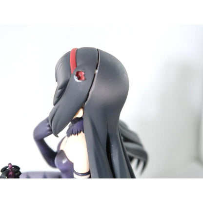 Close-up side view of a dark-haired anime figure on a white background.