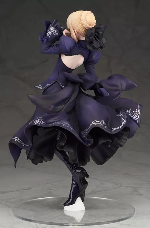 Blonde figure in a dark purple dress posed on a clear stand