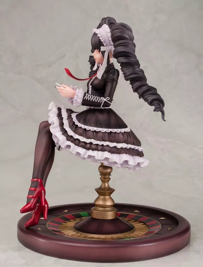 A seated female figure in a black-and-white dress on a round decorated base.