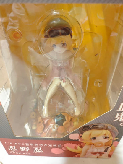 A boxed anime figure is visible through a clear plastic window with yellow backing.
