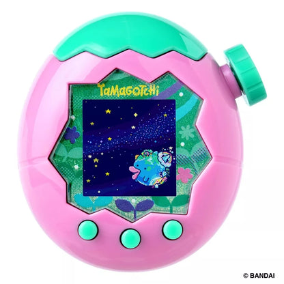 A pink Tamagotchi device with a green top and three green buttons on a white background.