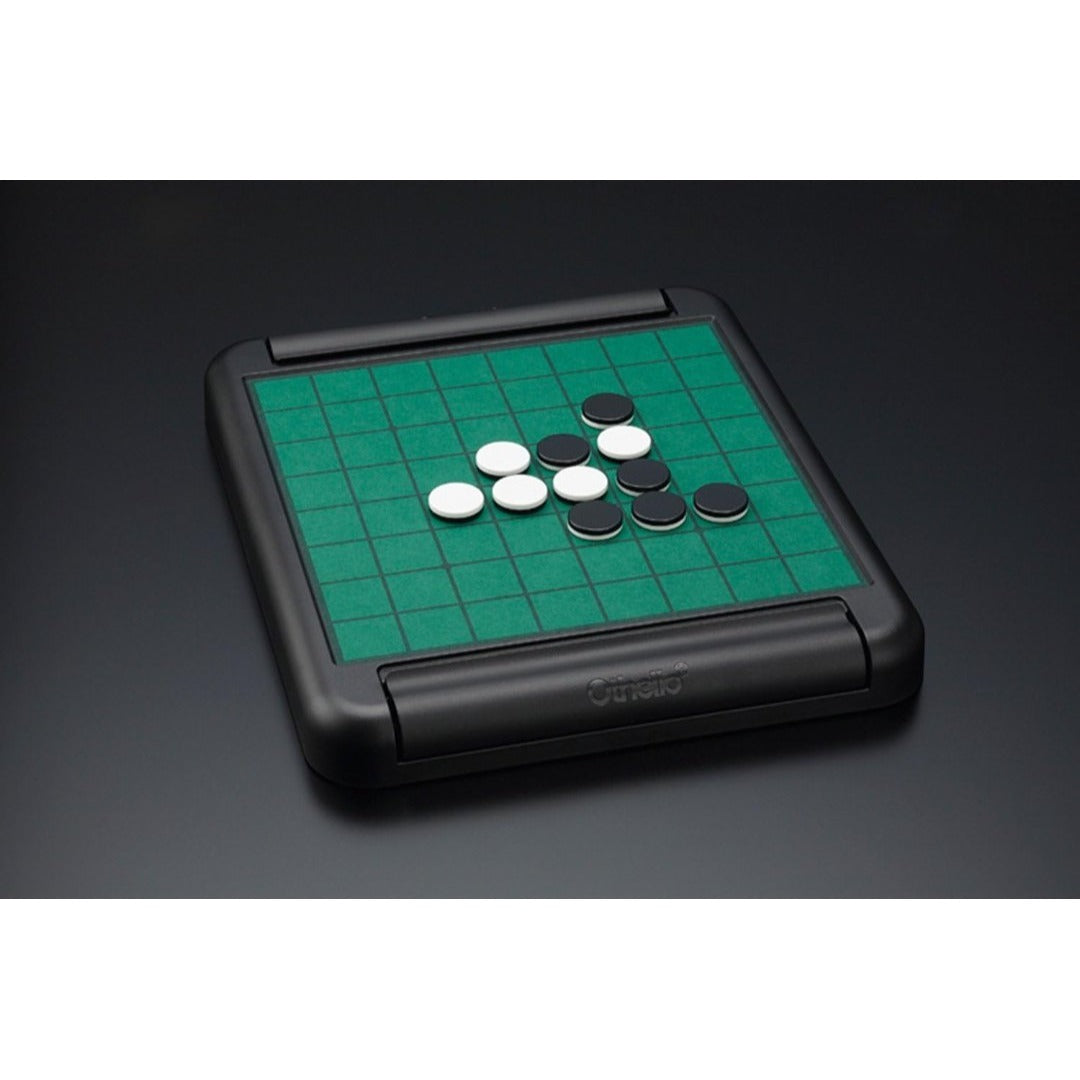 A black folding Othello board with green grid surface and several black and white discs.