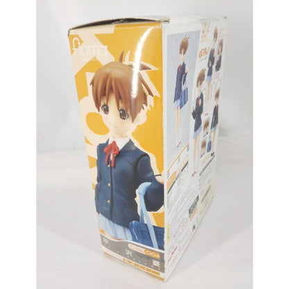 Angled view of a figma Ui Hirasawa box showing side artwork, rear pose photos, and wear along the top flap.