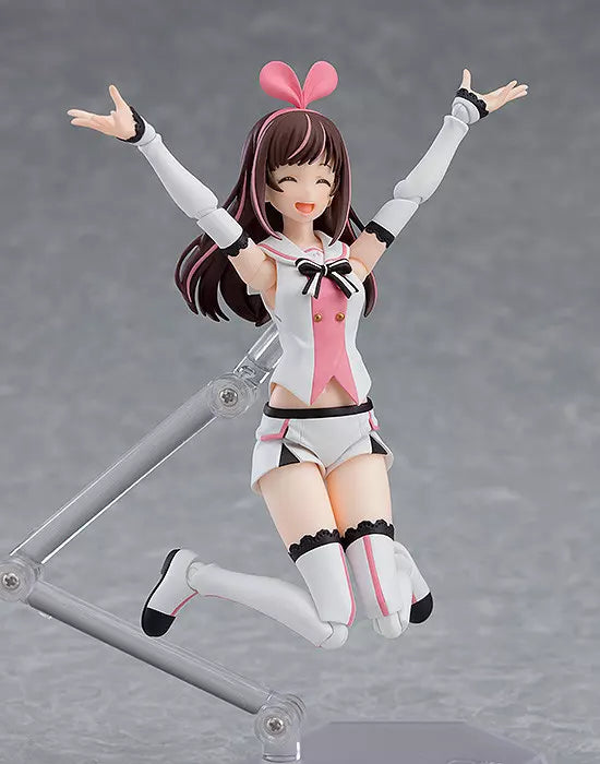 Kizuna AI figure posed with arms raised on a clear stand against a gray background