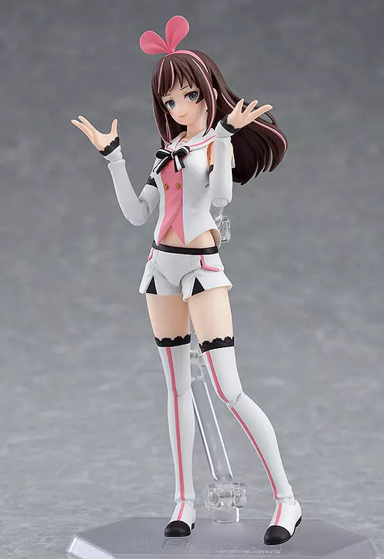 A Kizuna AI figure posing on a clear stand against a gray studio background.
