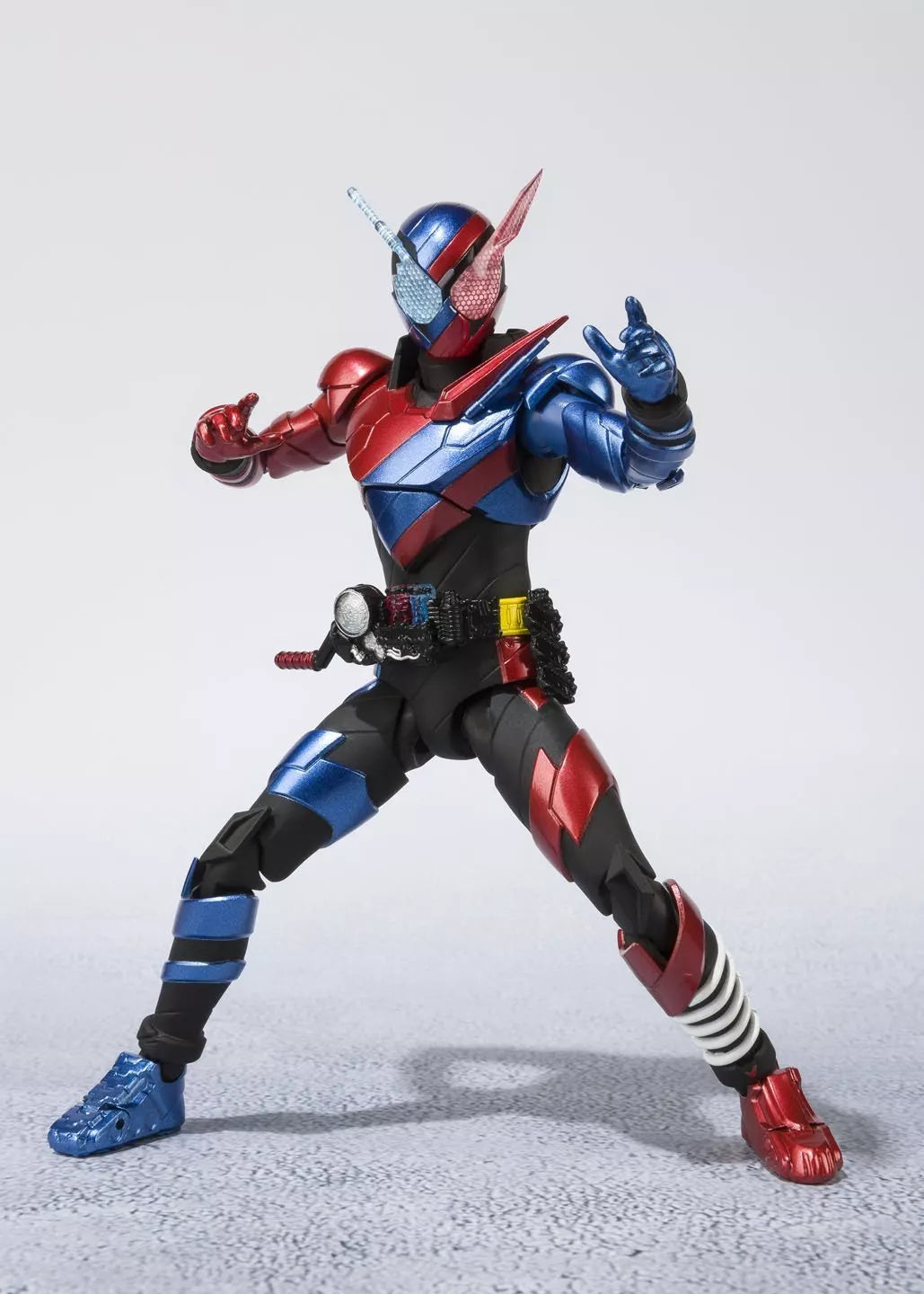 Kamen Rider Build Rabbit Tank Form figure posed with raised hands and spread legs on a light background.