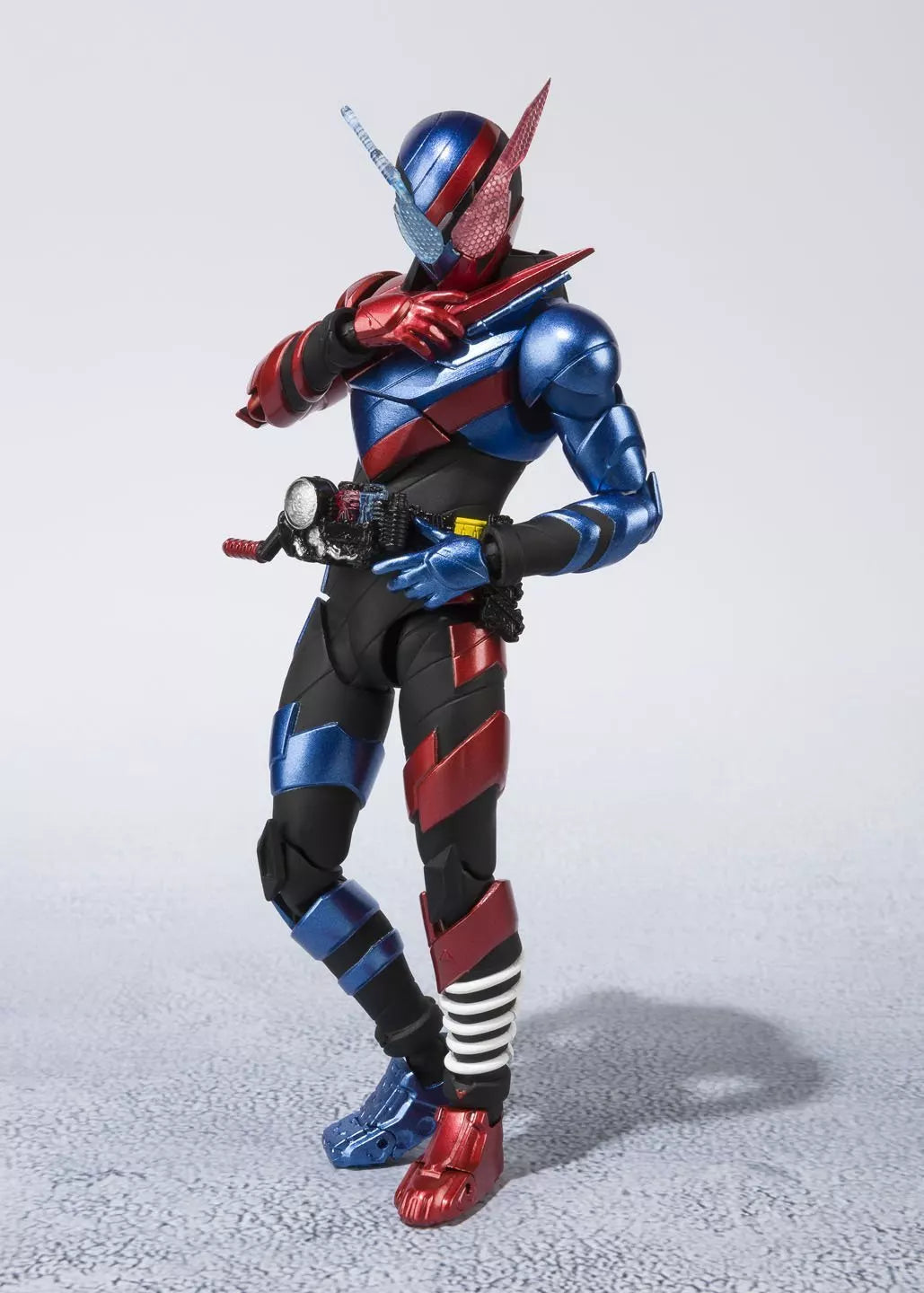 Kamen Rider Build Rabbit Tank Form figure posed with red and blue armor against a light background.