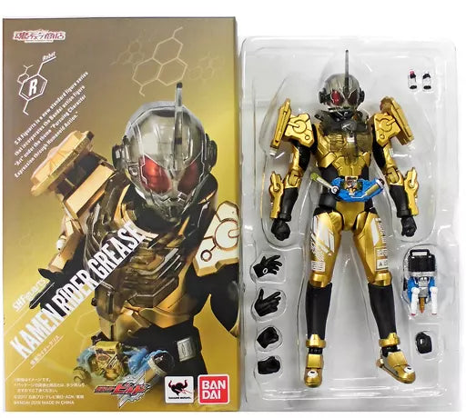Kamen Rider Grease figure in an inner blister with alternate hands and accessories beside its retail box.