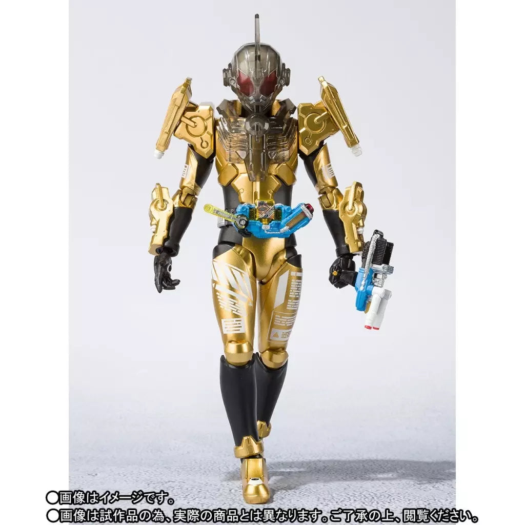Kamen Rider Grease figure in gold and black armor holding a weapon, with Japanese sample disclaimers below.