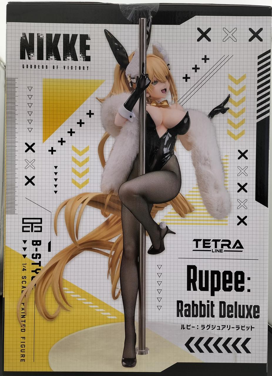 Front of a NIKKE Rupee: Rabbit Deluxe retail box featuring the blonde bunny-outfit figure on a pole.