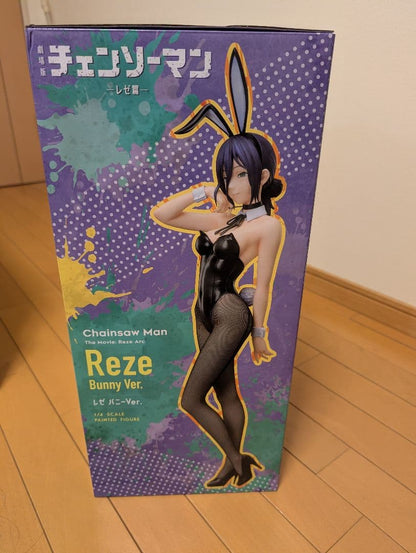 Front of a Reze Bunny Ver. retail box with purple and teal artwork, standing on a wooden floor.