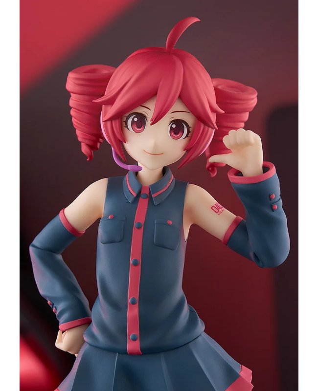 Red-haired anime girl figure in navy sleeveless outfit and red trim, posed with one hand raised, on a red back