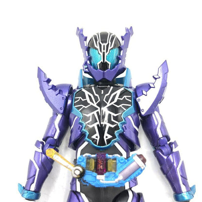 Purple and black Kamen Rider Rogue figure with blue visor and yellow-blue belt, shown in close-up on white bac