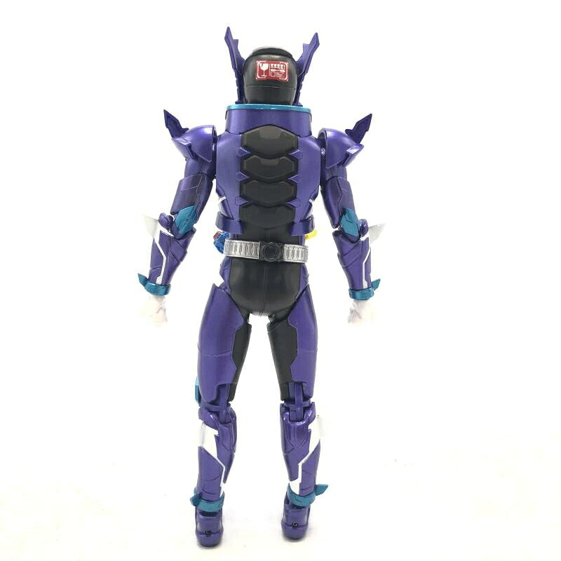 Purple and black Kamen Rider action figure seen from behind on a plain white background, with a red sticker on