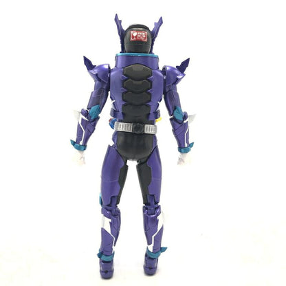 Purple and black Kamen Rider action figure seen from behind on a plain white background, with a red sticker on