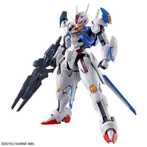 Gundam Aerial model posed with a dark rifle and shield, with white, blue, red and yellow armor.