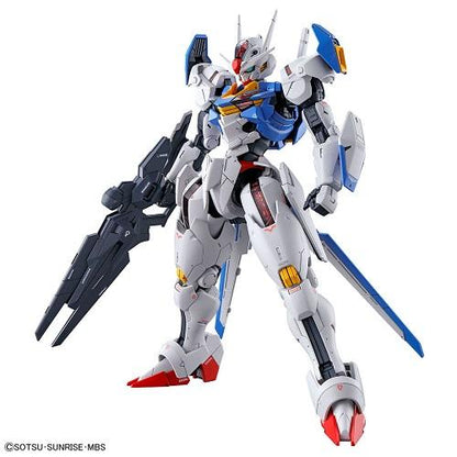 Gundam Aerial model posed with a dark rifle and shield, with white, blue, red and yellow armor.
