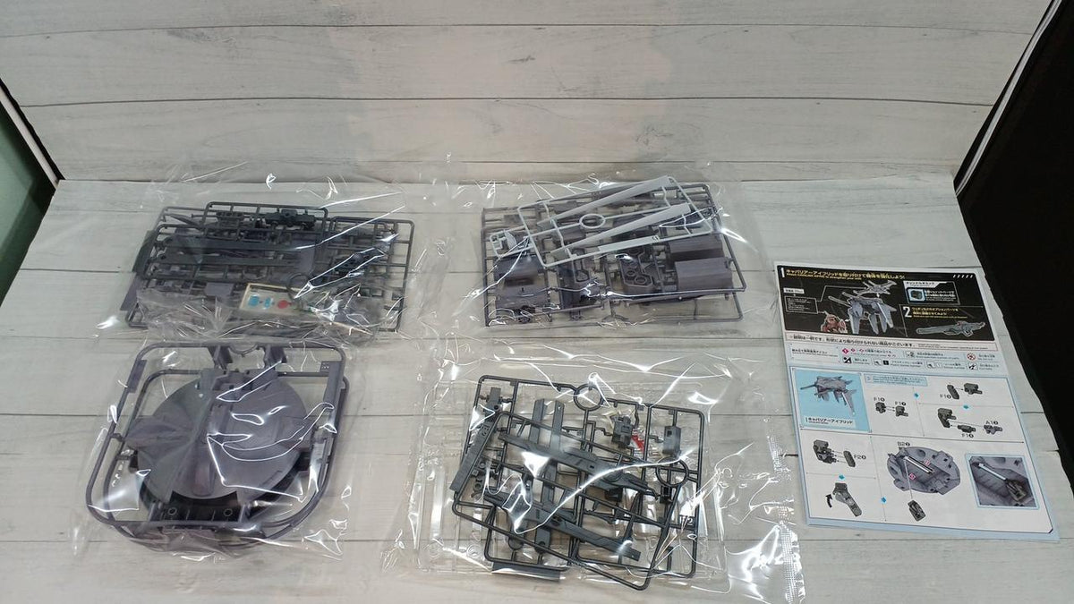 Bagged Cavalier Aifrid model kit runners and an instruction sheet laid out on a wood-patterned surface.
