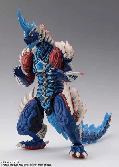 Blue horned monster figure with red chest armor, white spikes and a long tail against a gray studio background
