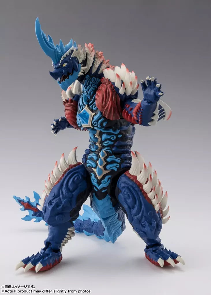 Blue horned monster figure with white spikes, red chest details, raised claws, and a long tail.