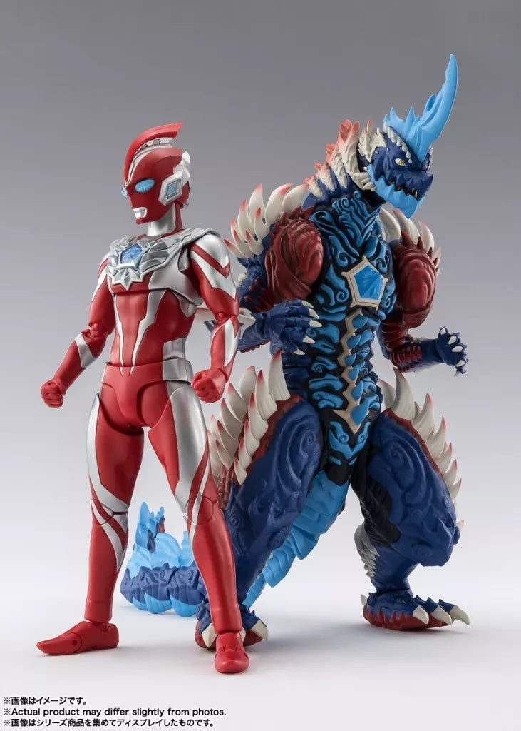Blue horned Lequinez figure with white spikes and red shoulders beside a red and silver Ultraman figure.