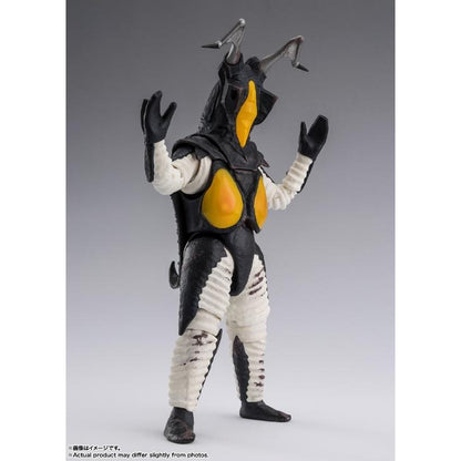 Zetton figure with raised hands, black armor, yellow chest panels and white limbs against a gray background.