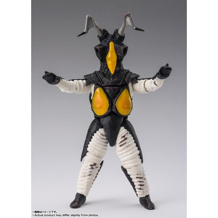 Zetton figure facing forward with raised arms, yellow facial and chest panels, against a gray studio backdrop.