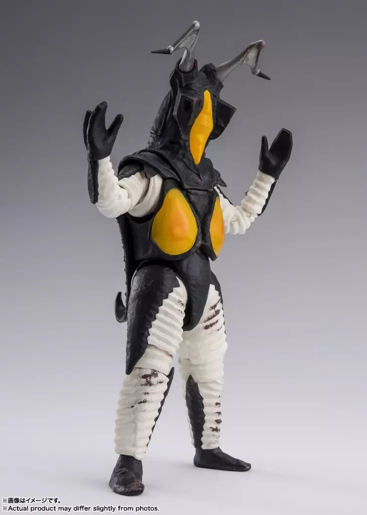 Zetton figure with raised arms, black armor, yellow chest panels, white limbs, and two horns.