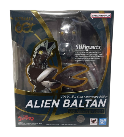 Front of a boxed S.H.Figuarts Alien Baltan 60th Anniversary Edition figure on a textured fabric surface. (cut-out)
