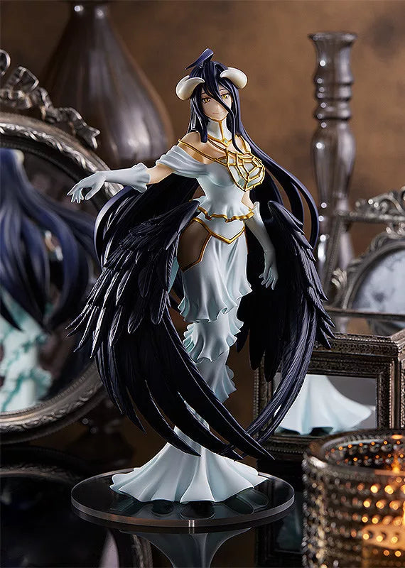 Albedo figure in a white dress with black wings on a round base, surrounded by mirrors and decorative objects.
