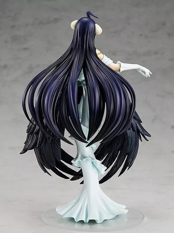 Rear view of Albedo figure with long dark hair, black wings and a white dress on a clear circular base.
