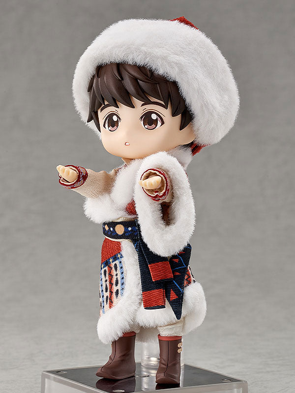 Brown-haired doll in a fur-trimmed hat and patterned winter outfit, standing on a base against gray.