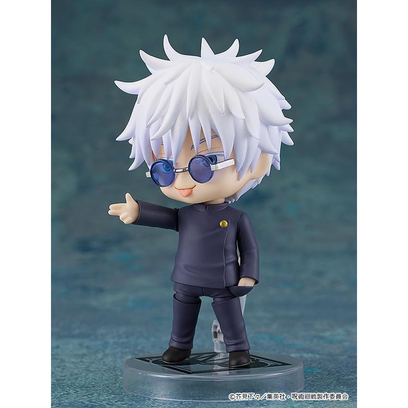 Gojo figure with white hair, blue round sunglasses and a dark school uniform, posed on a clear base.